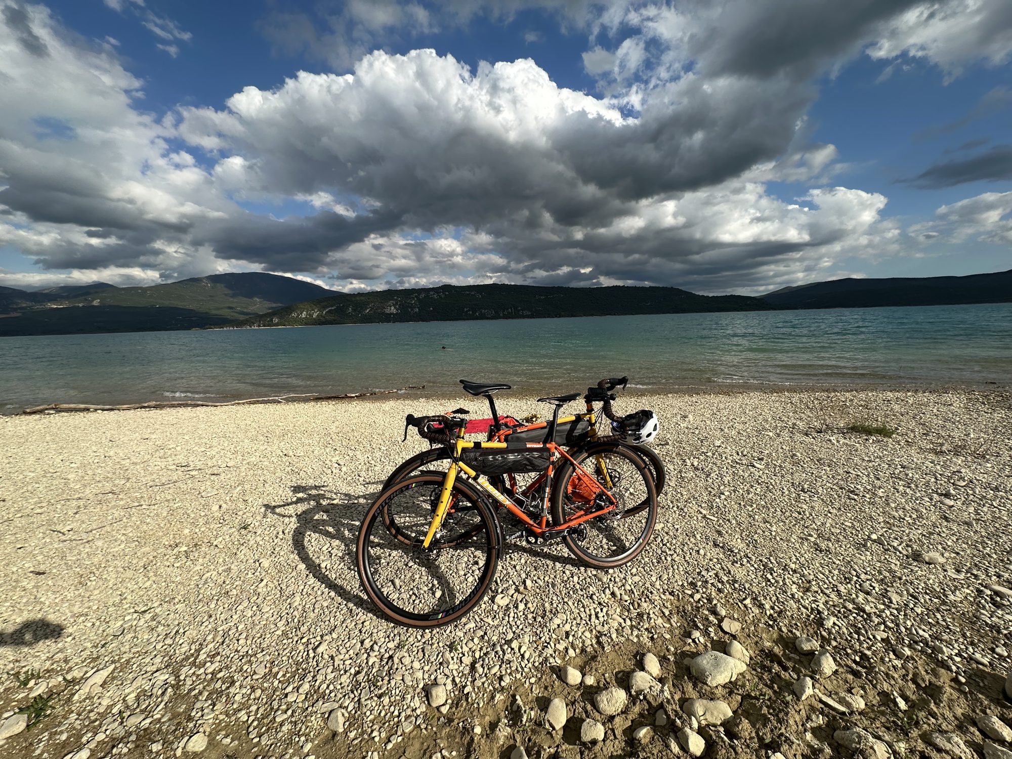 Two loaded bikes by an alpine lake